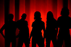 Metalband silhouetted in front of red wall